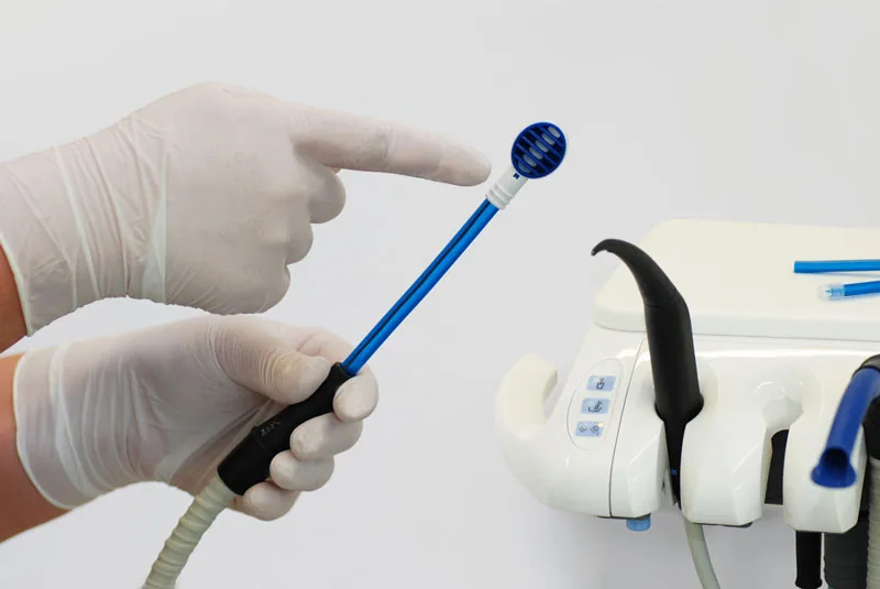 The TS1 tongue vacuum head being attached to the saliva ejector tubing on a chairside dental cart.